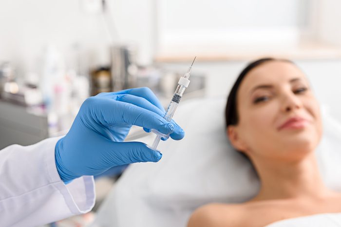 woman needle syringe botox procedure doctor