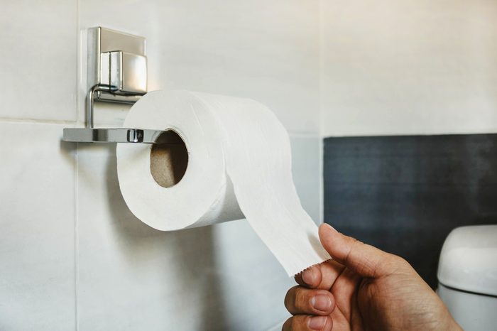 Wake up in the middle of the night | Hand picks a white toilet paper that hangs on the wall in the bathroom