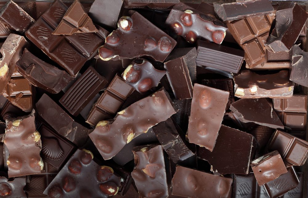 foods and drinks that cause migraines | Mix of chocolate bar pieces made of dark chocolate, milk chocolate / chocolate background