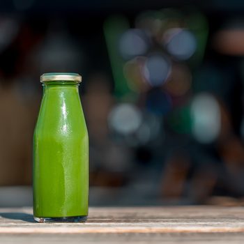 Raw vegetable juice in glass bottle