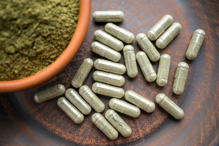 supplements and bowl of green powder