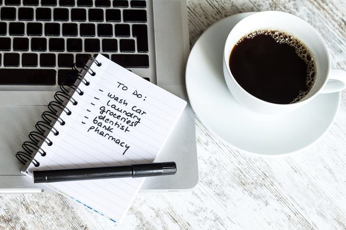 to-do list next to coffee cup and laptop
