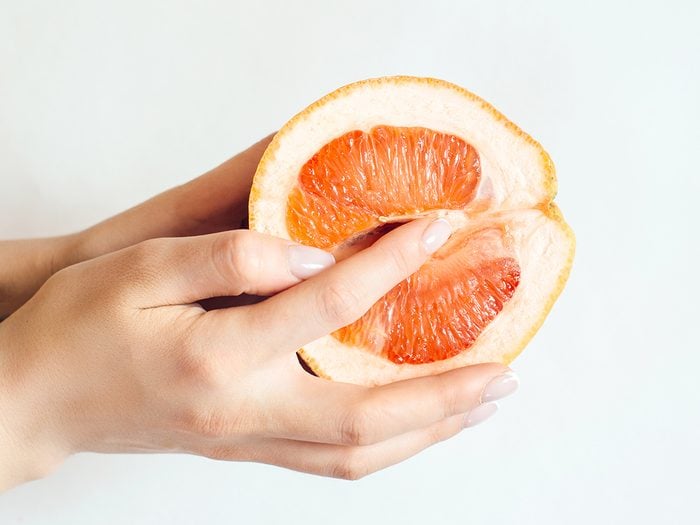 reasons to masturbate | Grapefruit,and,female,hands,on,blue,background.