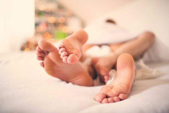 health myths gynecologists hear | couple's legs entwined in bed