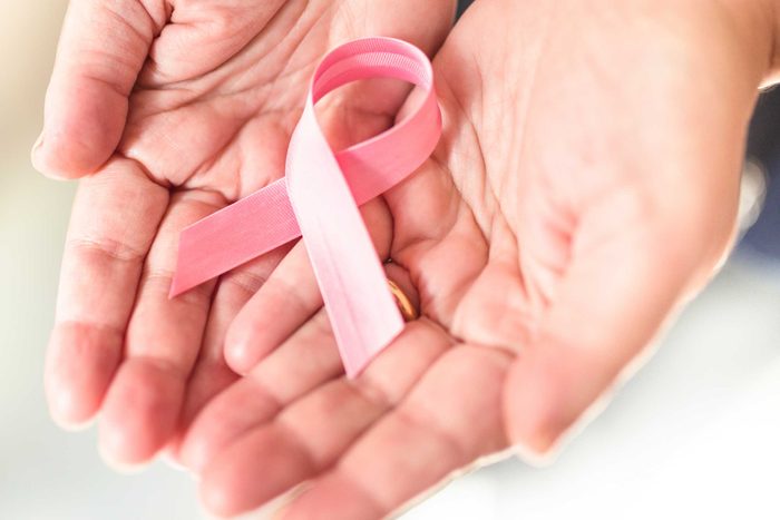 health myths gynecologists hear | hands holding pink breast cancer ribbon