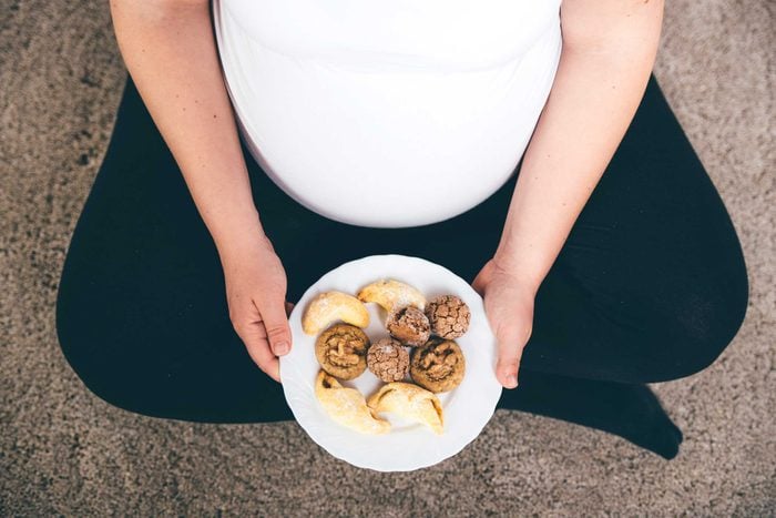 health myths gynecologists hear | pregnant woman with plate of food