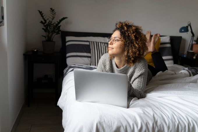 woman laying in bed with laptop