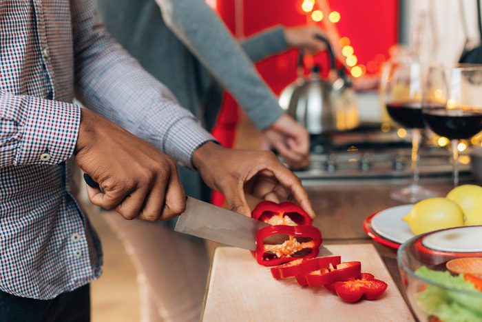 2020 | African-american man cutting bell pepper in kitchen