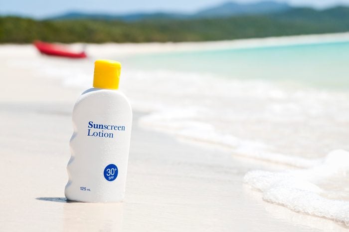 SPF 30 sunscreen lotion bottle on the beach