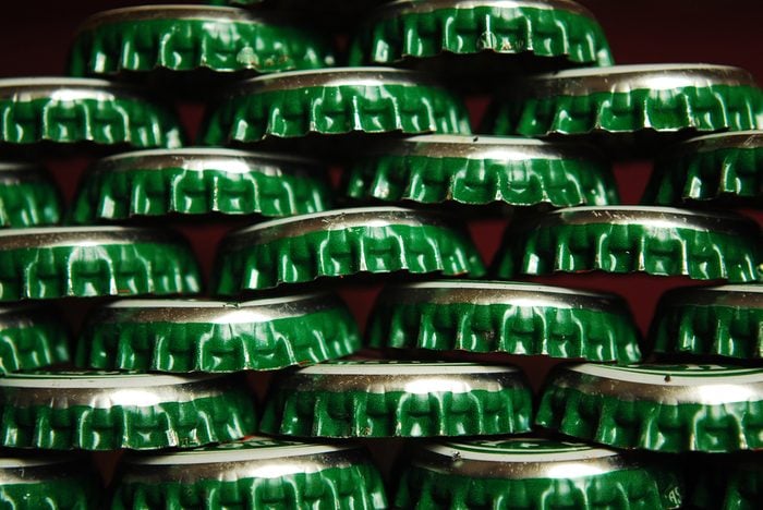 things that wreck your teeth | pile of green beer caps