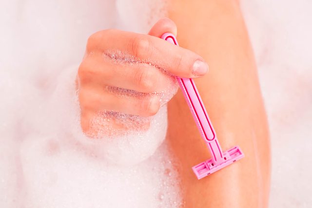 woman using pink razor