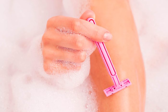 woman using pink razor
