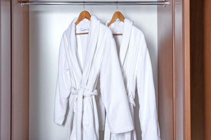 shouldn't be stored in the bathroom | Spa bathrobes hanging in wardrobe