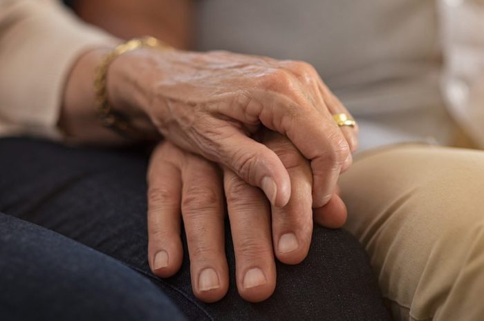 early-onset Alzheimer's | elderly couple holding hands comforting each other