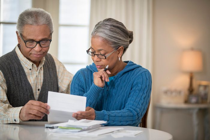 early-onset Alzheimer's | mature couple paying bills at home