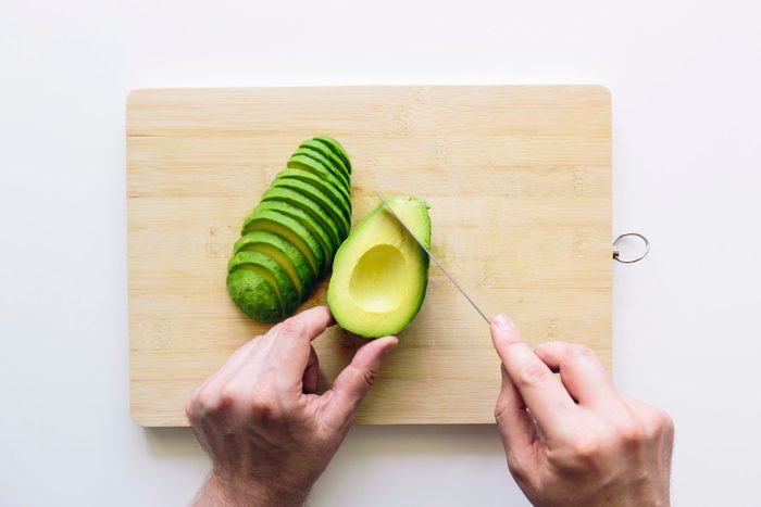 doctors eat for breakfast | overhead shot of man slicing avocado