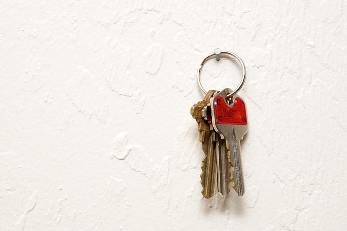 early-onset Alzheimer's | A keyring with three keys hanging on nail on wall.