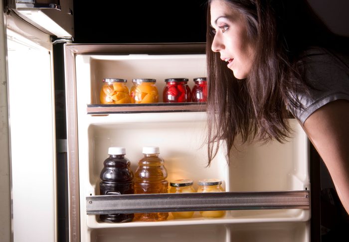 maintain a healthy weight | woman looking into a refrigerator