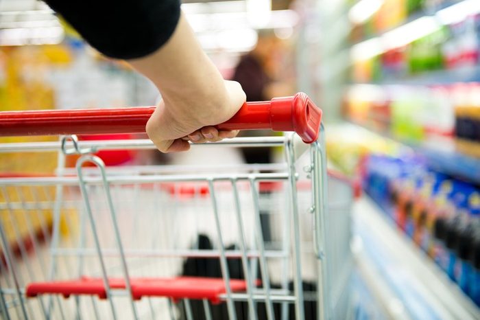 generic food brands | Closeup of woman with shopping cart