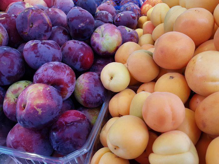 healthier grilling ideas | Plums and apricots at the market, in summer
