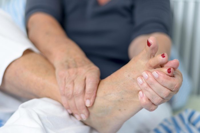 type 2 diabetes complications | hands holding foot
