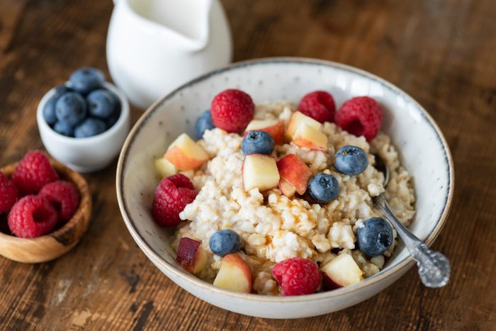 diabetic breakfast | Oatmeal porridge with berries and honey on wooden table
