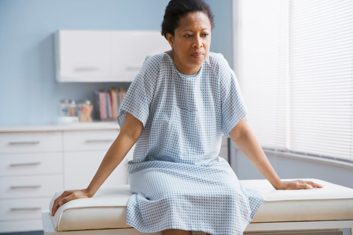 breast cancer prevention | female patient sitting on examination table in doctor's office