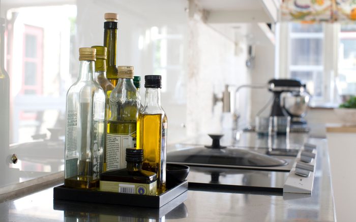 healthiest cooking oils | oil Bottles on kitchen worktop, close-up