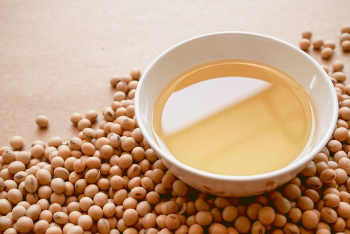 healthiest cooking oils | oil and soybeans on brown paper