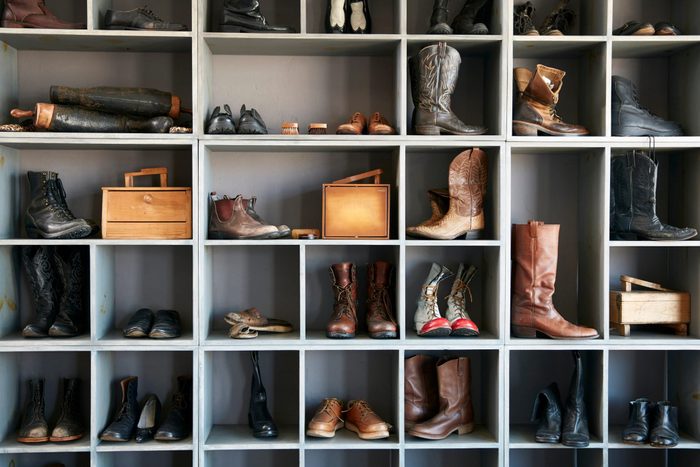 Display of boots and shoes on shelves in traditional shoe shop