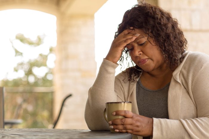 can can anxiety cause high blood pressure | African American middle age woman looking sad.