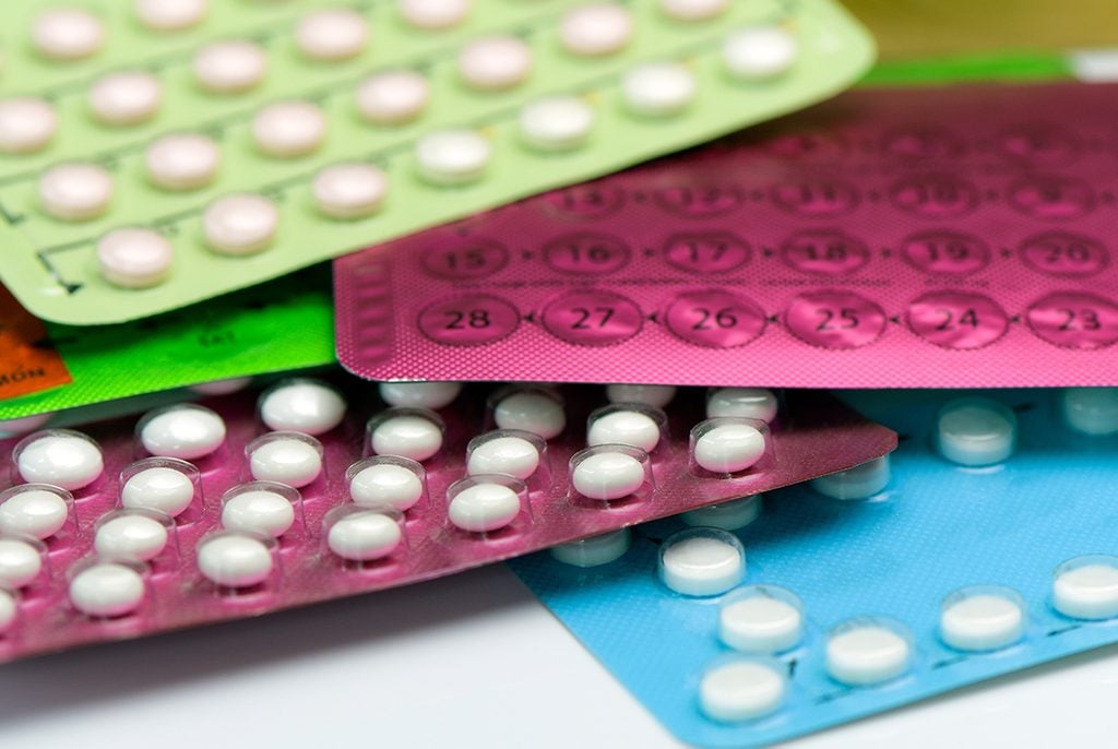 birth control switch | a pile of birth control pills on a white table