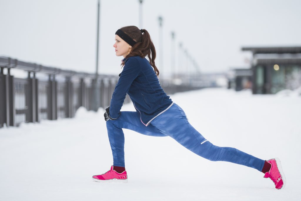 thermal leggings | woman stretching in the snow