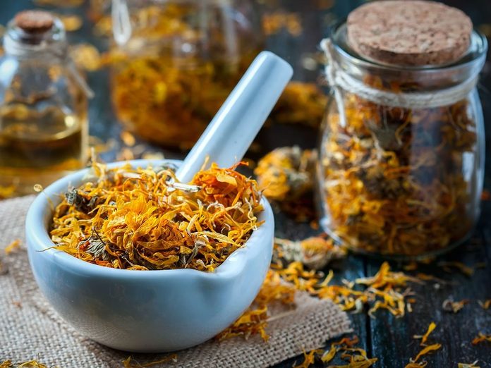 Calendula flowers in stone mixing bowl.