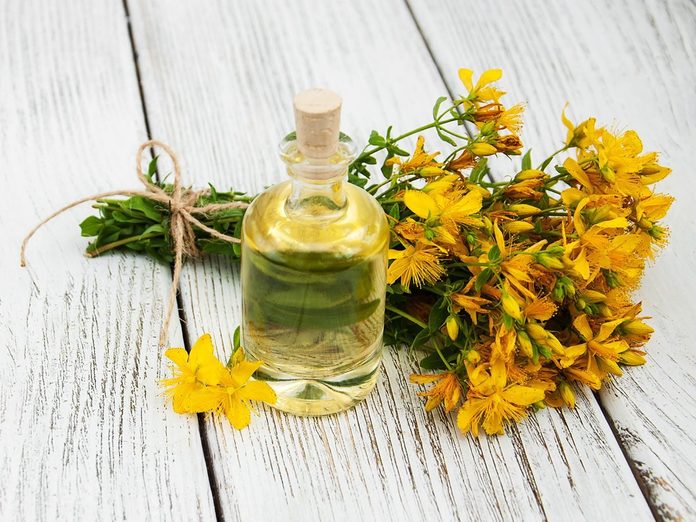 St. John's wort extract on the wooden table.