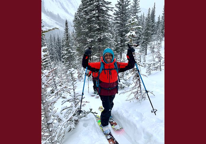 being outdoors | image of author Deja Leonard in the snow with skis