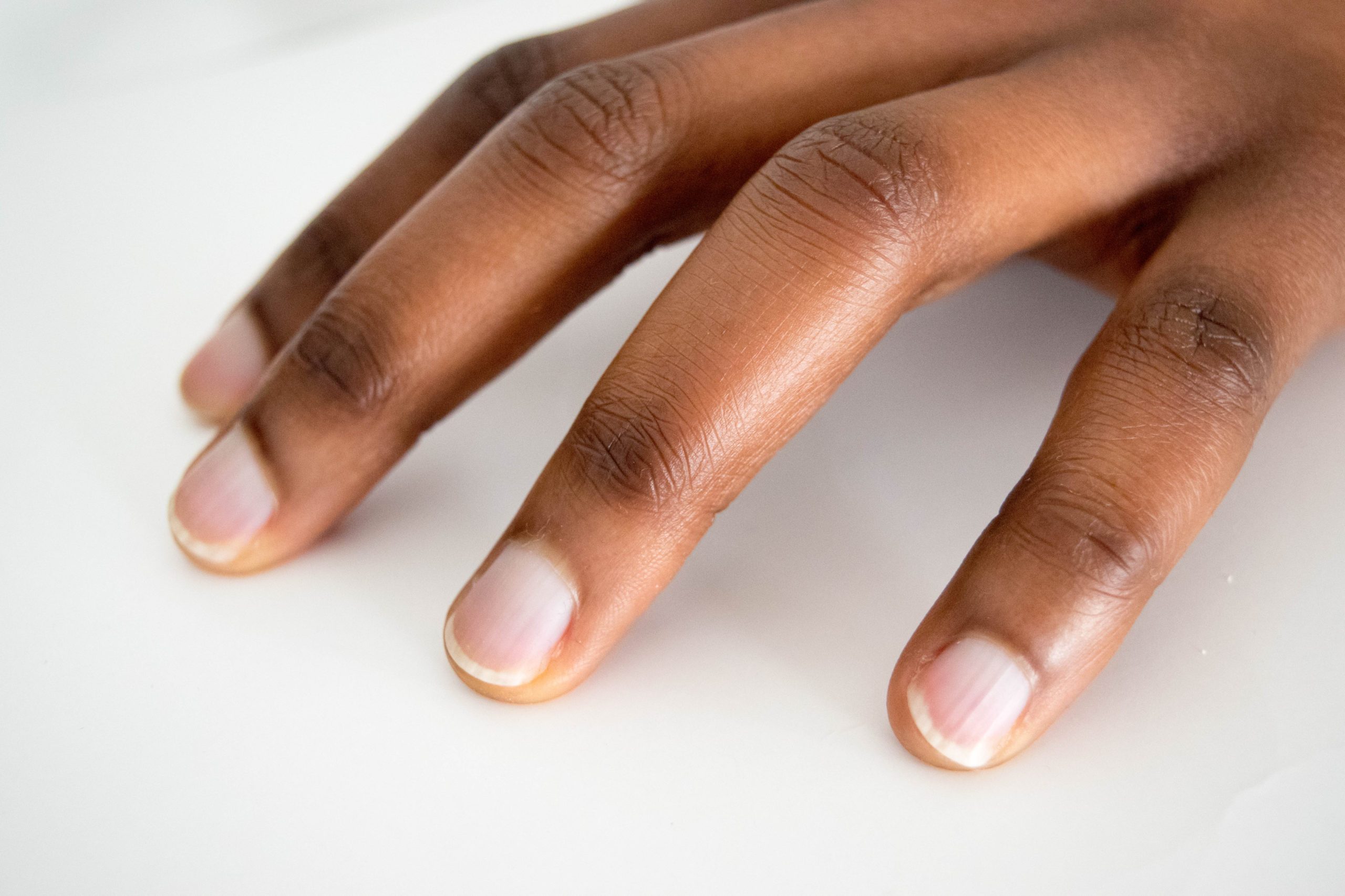 African,american,dark,brown,skin,woman,hand,with,french,manicure
