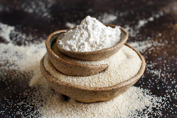 fonio | Raw Fonio Flour And Seeds In Bowls On Dark Background
