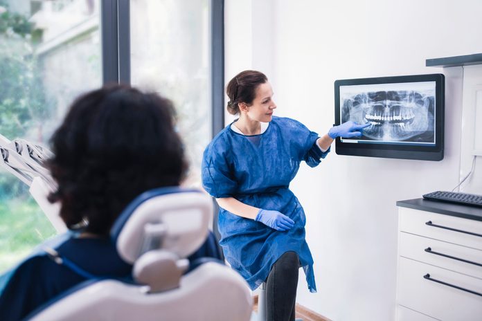 wisdom teeth removal | Dentist Explaining Tooth X Rays To A Patient