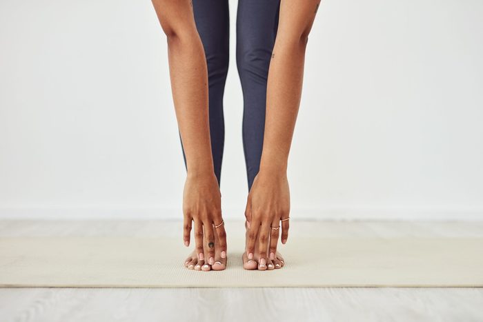 types of stretching | closeup of woman touching her toes