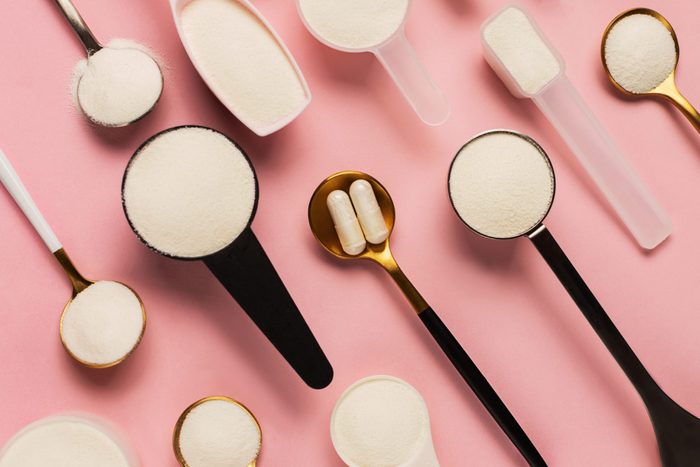 collagen powder | flat lay image of collagen supplements in spoons on a pink background