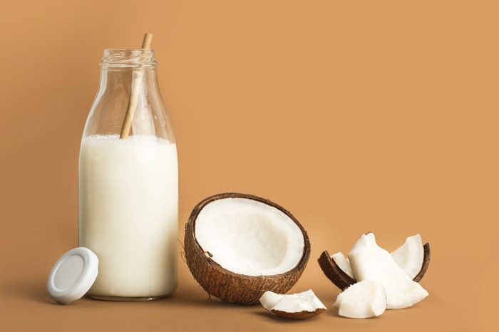 coconut milk | A Bottle Of Coconut Milk And Pieces Of Coconut