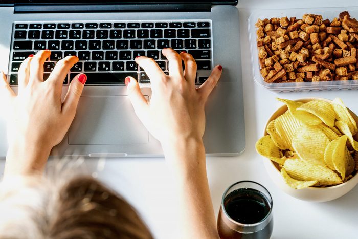 stress undereating | hands on a keyboard with food next to it