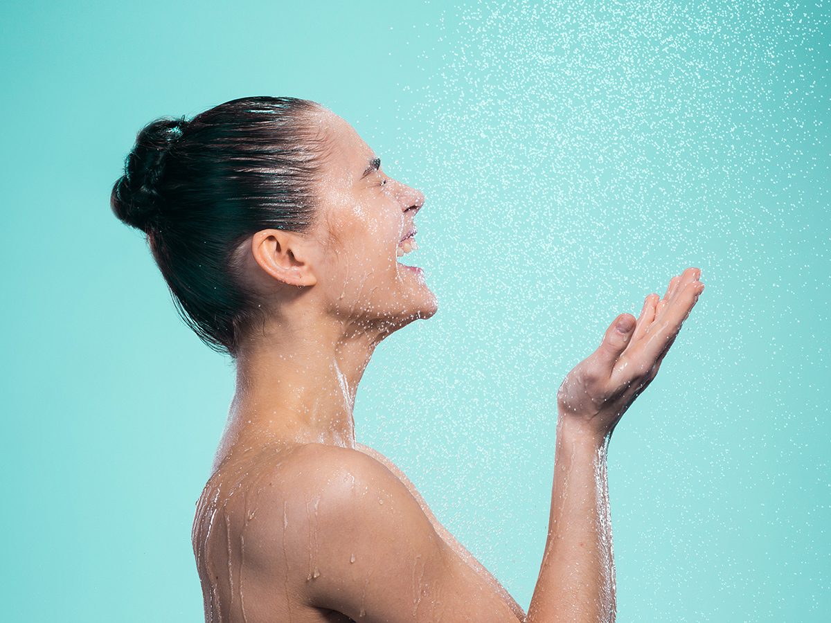 wash face in shower | Woman,enjoying,water,in,the,shower,under,a,shower,jet