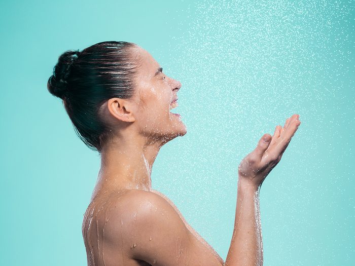 wash face in shower | Woman,enjoying,water,in,the,shower,under,a,shower,jet