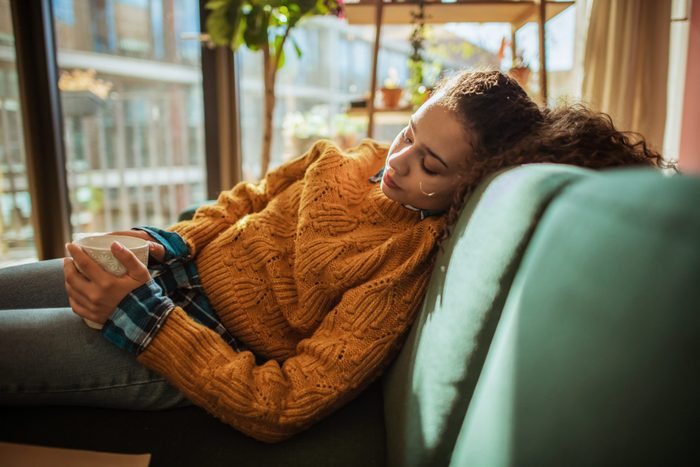 can allergies make you tire | Woman Is Resting On The Sofa In Her Apartment