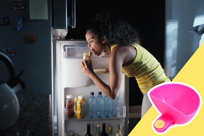woman eating sandwich out of fridge with inset of a dip container