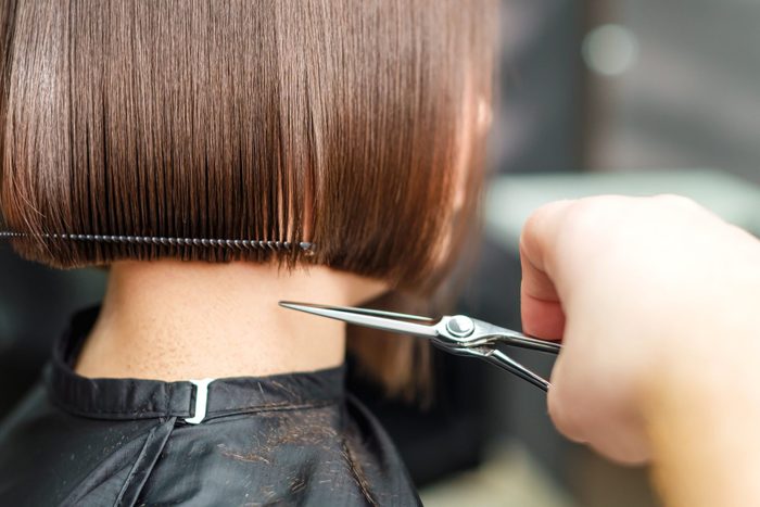 How much to tip your hairdresser- Hairdressers Hands Are Cutting Brown Short Hair
