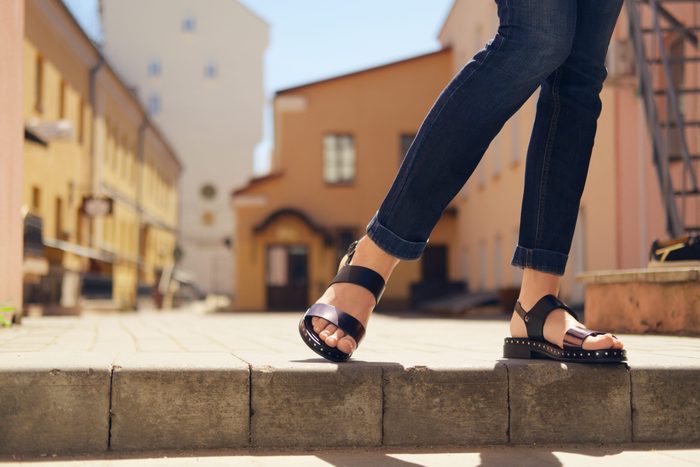 womens sandals canada | someone wearing comfortable sandals standing on a ledge