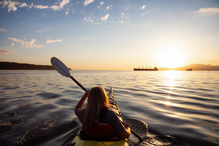 aquafit | woman paddling a canoe on a lake